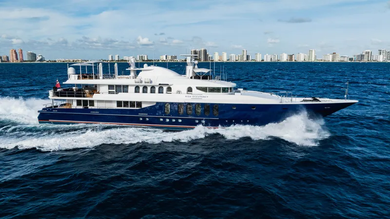 High Occupancy Yacht Photos Pics Luxurious 1989 Oceanfast Custom yacht cruising on the ocean with city skyline backdrop.
