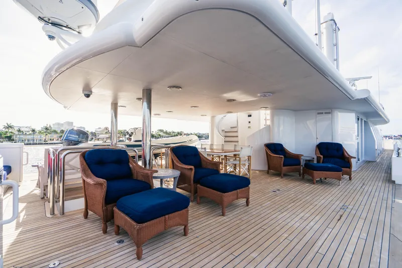 High Occupancy Yacht Photos Pics Luxurious Oceanfast Custom yacht deck with wicker chairs, blue cushions, and wooden flooring, 1989 model.
