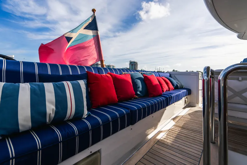 High Occupancy Yacht Photos Pics Luxurious 1989 Oceanfast Custom yacht deck with striped seating and vibrant cushions.