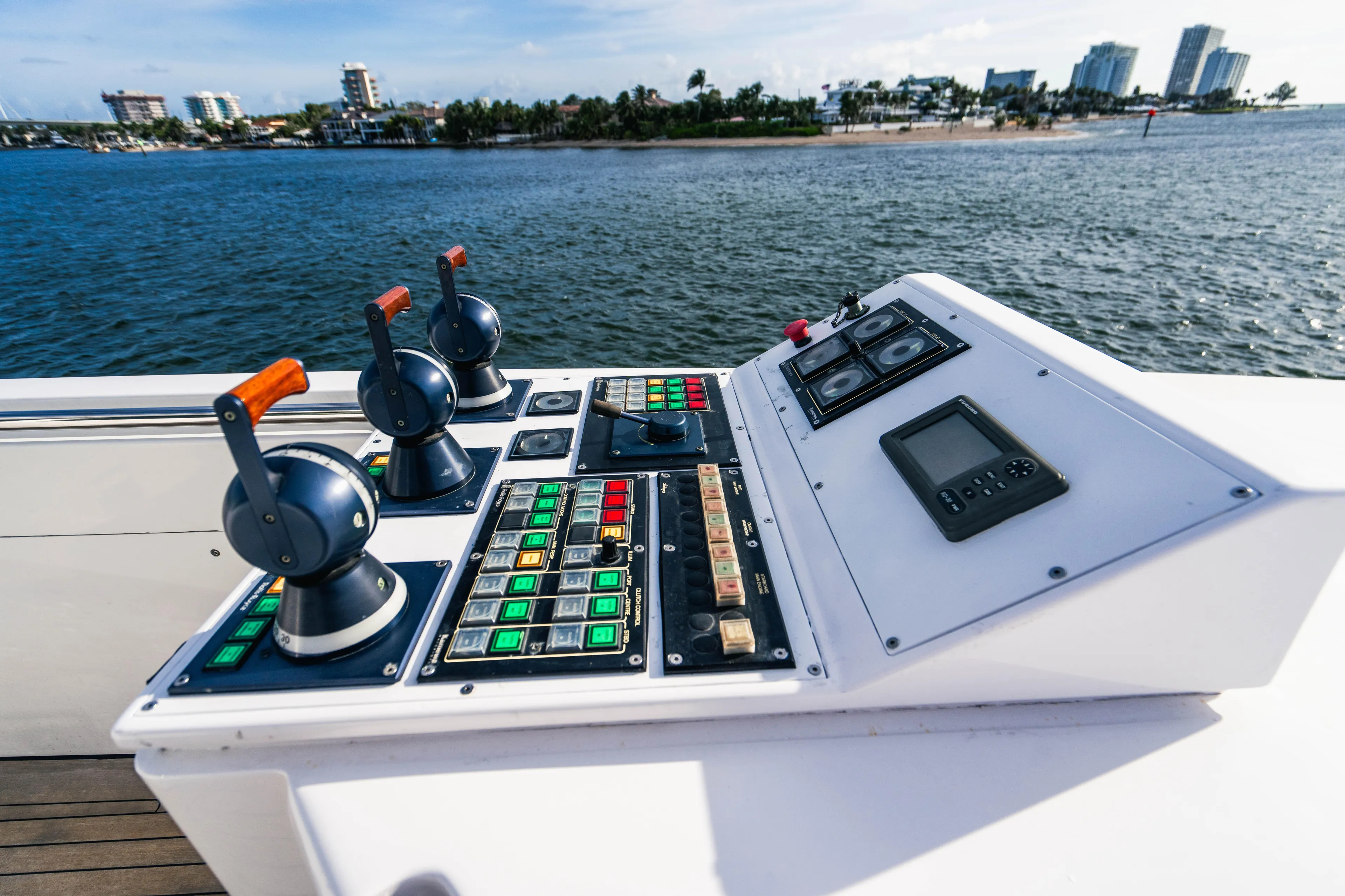 High Occupancy Yacht Photos Pics Control panel on 1989 Oceanfast Custom yacht, overlooking coastal cityscape.