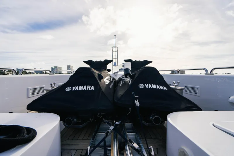 High Occupancy Yacht Photos Pics Two Yamaha jet skis on Oceanfast Custom yacht, 1989 model, under a cloudy sky.