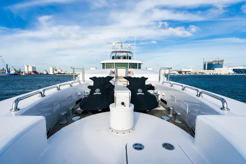 High Occupancy Yacht Photos Pics Luxurious 1989 Oceanfast Custom yacht deck with city skyline and blue sky backdrop.