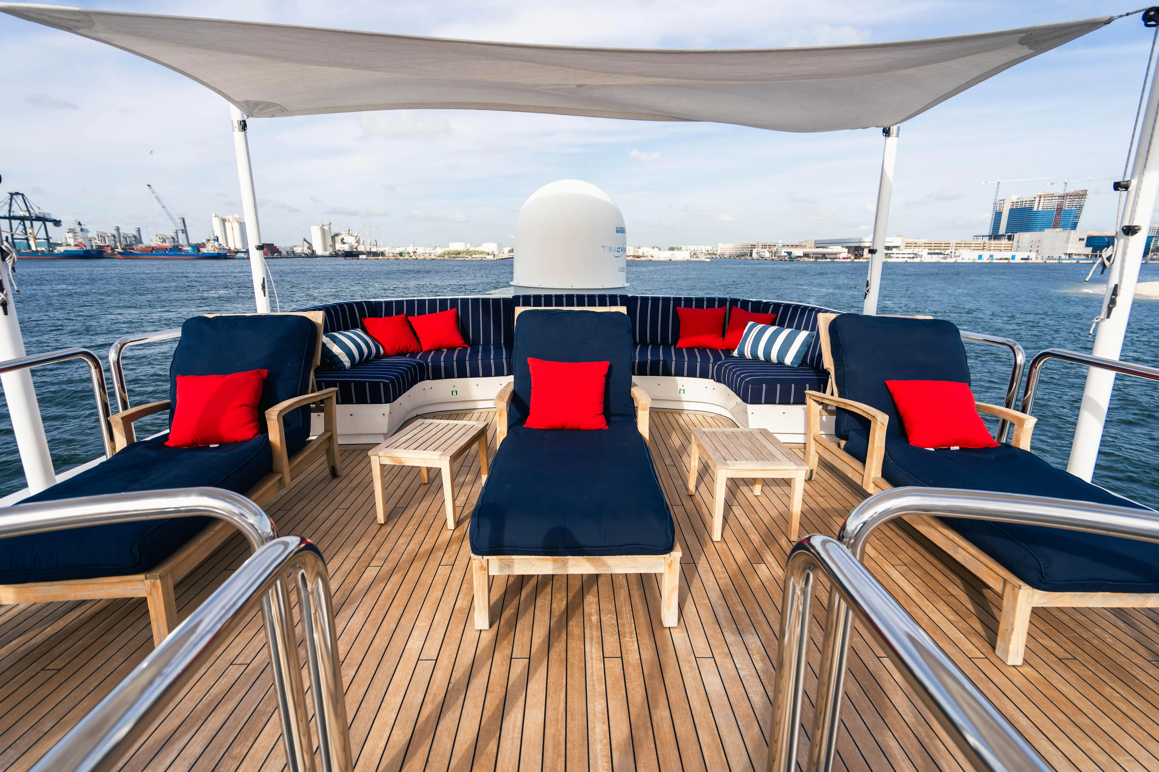 High Occupancy Yacht Photos Pics Luxurious 1989 Oceanfast Custom yacht deck with blue loungers and red cushions.