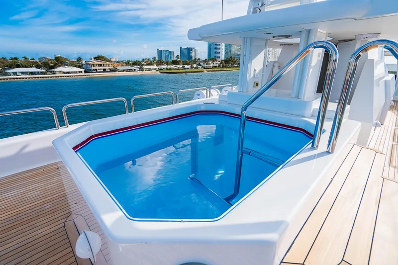 High Occupancy Yacht Photos Pics Luxurious Oceanfast Custom yacht with pool, 1989 model, docked by scenic waterfront.