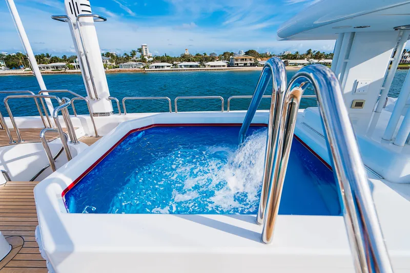 High Occupancy Yacht Photos Pics Luxurious yacht jacuzzi on Oceanfast Custom, 1989, with ocean view and clear blue skies.