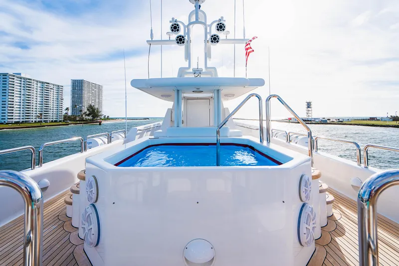High Occupancy Yacht Photos Pics Luxurious 1989 Oceanfast Custom yacht with pool, docked near modern waterfront buildings.