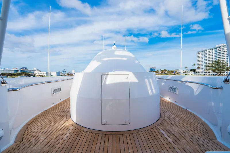 High Occupancy Yacht Photos Pics Luxurious Oceanfast Custom yacht deck with wooden flooring, 1989 model, under a clear blue sky.