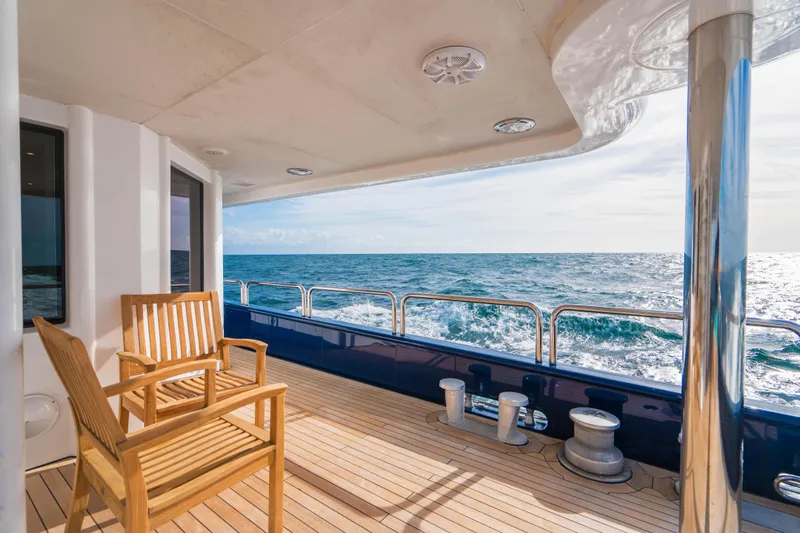 High Occupancy Yacht Photos Pics Oceanfast Custom 1989 yacht deck with wooden chairs overlooking the ocean.