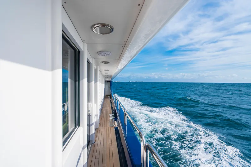 High Occupancy Yacht Photos Pics Oceanfast Custom 1989 yacht deck with ocean view and clear blue sky.