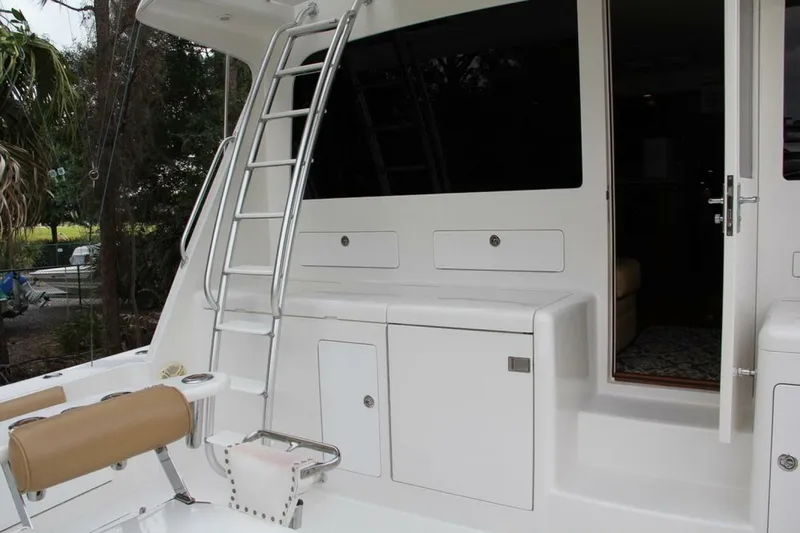 Merry Yacht Yacht Photos Pics 2004 Cabo 48 Flybridge yacht with ladder and open cabin door.