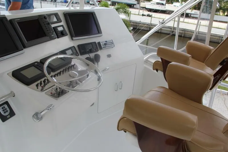 Merry Yacht Yacht Photos Pics 2004 Cabo 48 Flybridge helm with advanced navigation systems and luxurious seating.