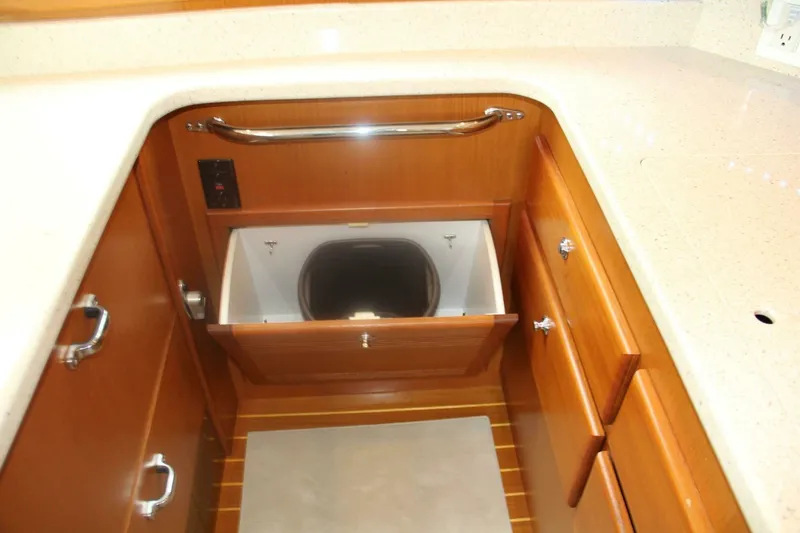 Merry Yacht Yacht Photos Pics 2004 Cabo 48 Flybridge kitchen with open drawer and trash bin.