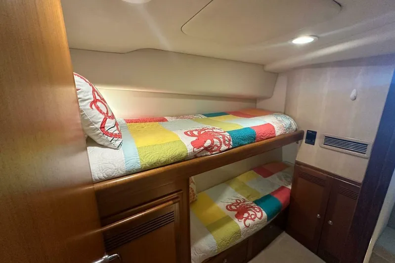 Merry Yacht Yacht Photos Pics Bunk beds in 2004 Cabo 48 Flybridge yacht cabin with colorful bedding.