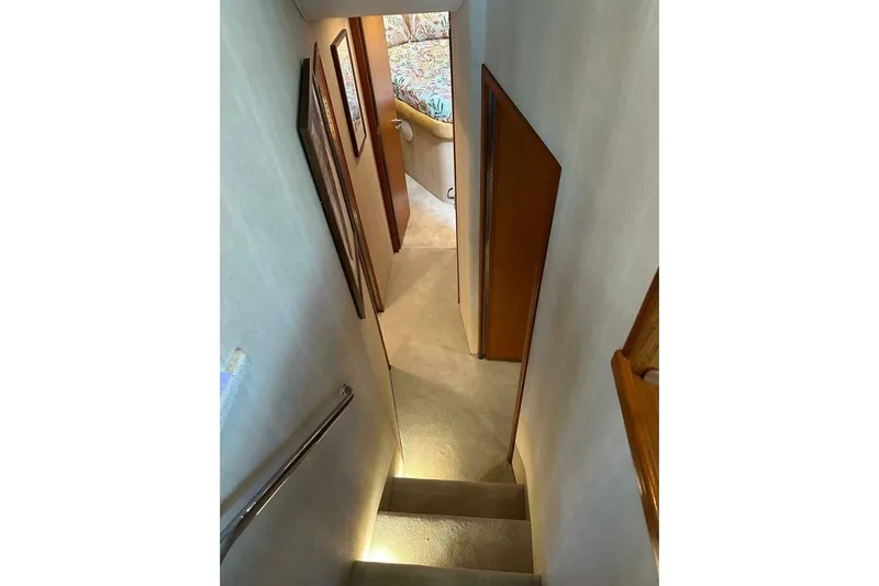 Merry Yacht Yacht Photos Pics Stairway inside 2004 Cabo 48 Flybridge yacht, leading to a cozy cabin area.
