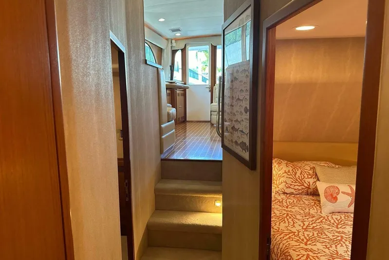 Merry Yacht Yacht Photos Pics Interior of 2004 Cabo 48 Flybridge yacht, featuring cozy cabin and elegant wood finishes.