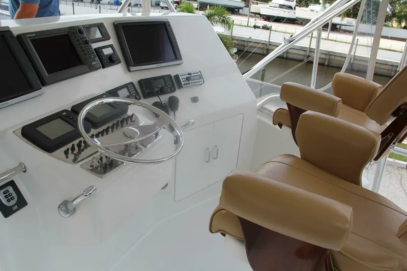 Merry Yacht Yacht Photos Pics 2004 Cabo 48 Flybridge helm with navigation equipment and leather captain's chairs.