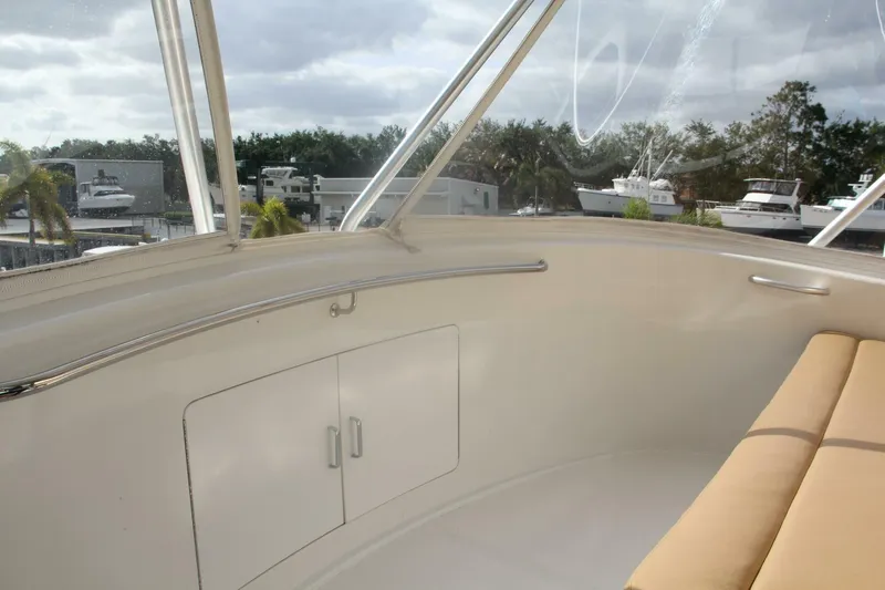 Merry Yacht Yacht Photos Pics 2004 Cabo 48 Flybridge interior with beige seating and marina view.