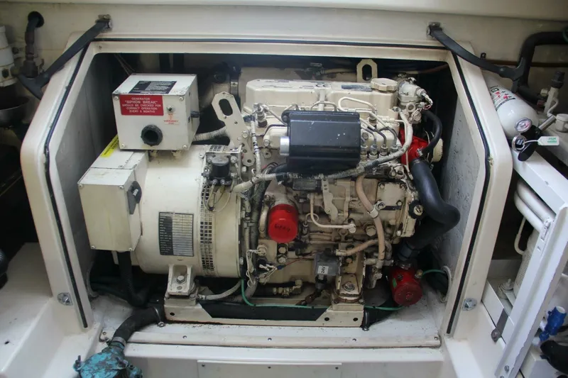 Merry Yacht Yacht Photos Pics Engine compartment of a 2004 Cabo 48 Flybridge boat, showcasing detailed machinery.