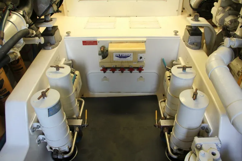Merry Yacht Yacht Photos Pics Engine room of 2004 Cabo 48 Flybridge with fuel filters and mechanical components.