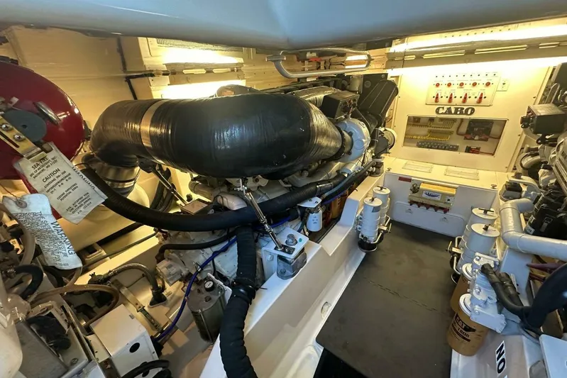 Merry Yacht Yacht Photos Pics Engine room of a 2004 Cabo 48 Flybridge yacht, showcasing mechanical components and systems.