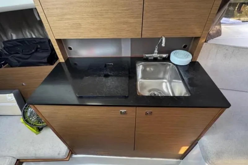  Yacht Photos Pics Compact kitchenette in 2020 Jeanneau Leader 9.0 WA boat with sink and countertop.