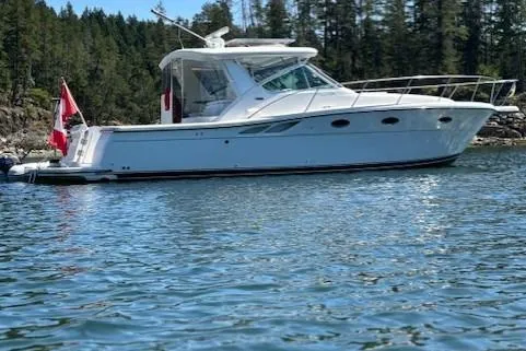 Ocean Cloud Yacht Photos Pics 2001 Tiara Yachts 3500 Open boat on calm water with forested background.