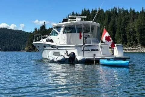 Ocean Cloud Yacht Photos Pics 2001 Tiara Yachts 3500 Open boat on serene lake with Canadian flag.