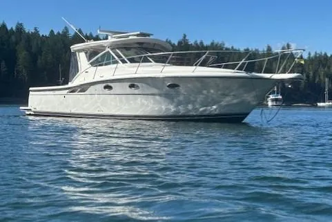 Ocean Cloud Yacht Photos Pics 2001 Tiara Yachts 3500 Open cruising on calm waters, forested shoreline in background.