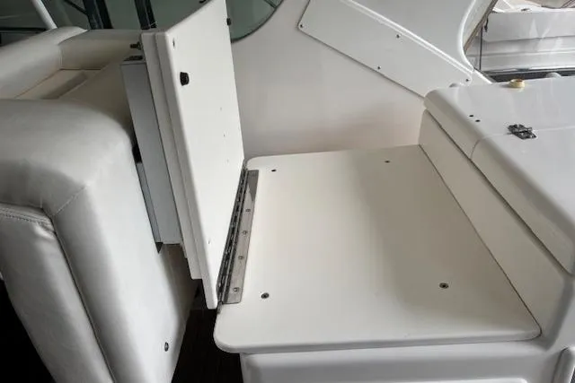 Ocean Cloud Yacht Photos Pics 2001 Tiara Yachts 3500 Open interior seating area with white upholstery and storage compartment.