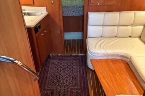 Ocean Cloud Yacht Photos Pics Interior of 2001 Tiara Yachts 3500 Open with white seating and wooden accents.