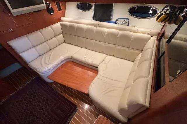 Ocean Cloud Yacht Photos Pics Luxurious interior of 2001 Tiara Yachts 3500 Open with plush seating and wood flooring.