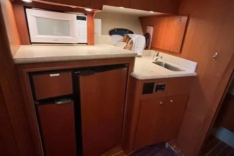 Ocean Cloud Yacht Photos Pics 2001 Tiara Yachts 3500 Open galley with microwave, sink, and compact refrigerator.