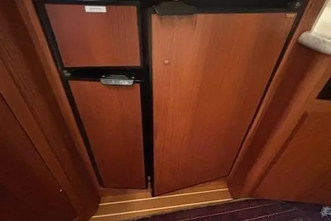 Ocean Cloud Yacht Photos Pics 2001 Tiara Yachts 3500 Open interior with wooden cabinetry and compact refrigerator.