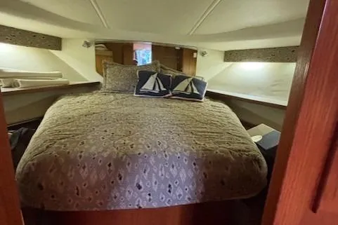 Ocean Cloud Yacht Photos Pics 2001 Tiara Yachts 3500 Open cabin interior with cozy bed and nautical-themed pillows.