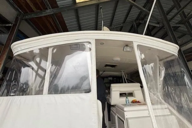 Ocean Cloud Yacht Photos Pics 2001 Tiara Yachts 3500 Open, docked indoors, featuring clear enclosure and seating area.