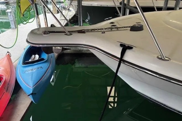 Ocean Cloud Yacht Photos Pics 2001 Tiara Yachts 3500 Open docked, with kayaks nearby in a marina setting.