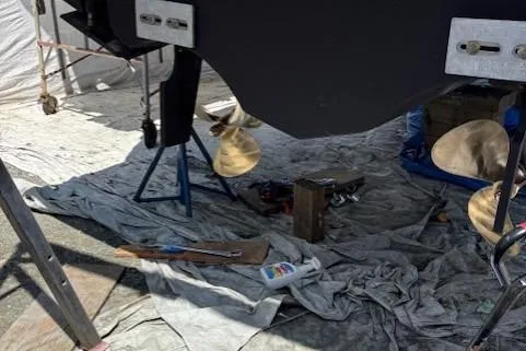 Ocean Cloud Yacht Photos Pics 2001 Tiara Yachts 3500 Open under maintenance, showing propellers and tools on a tarp.