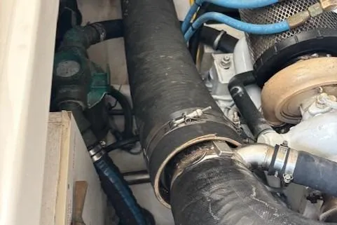 Ocean Cloud Yacht Photos Pics Engine compartment of a 2001 Tiara Yachts 3500 Open, showcasing hoses and mechanical components.