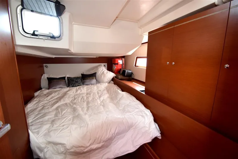  Yacht Photos Pics Luxurious cabin interior of 2019 Beneteau 51.1 yacht with cozy bedding.