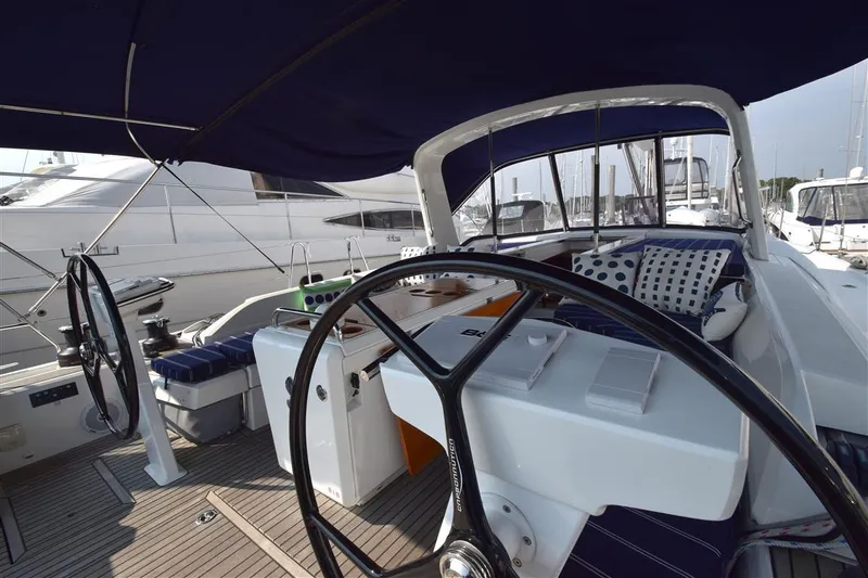  Yacht Photos Pics 2019 Beneteau 51.1 yacht cockpit with dual steering wheels and cushioned seating.