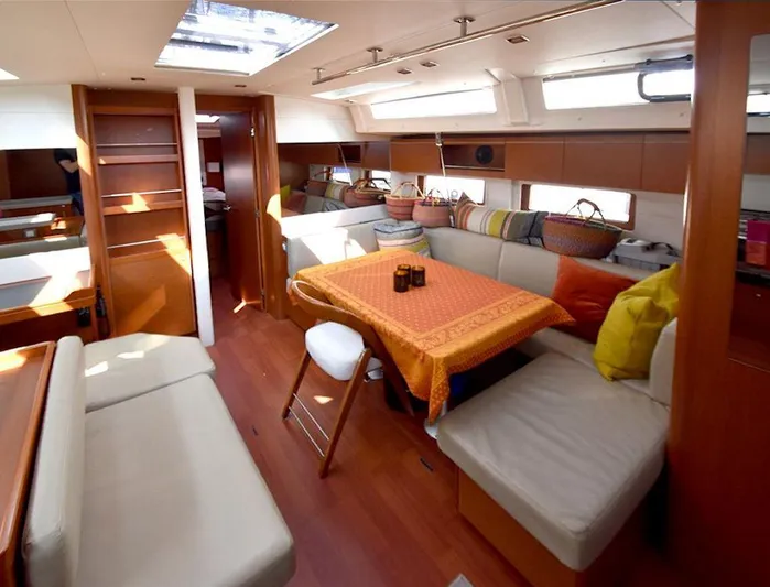  Yacht Photos Pics Interior of 2019 Beneteau 51.1 yacht with cozy seating and dining area.