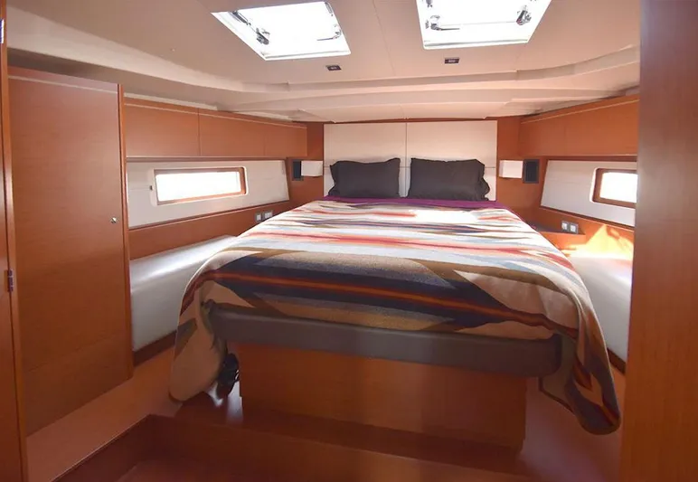  Yacht Photos Pics Luxurious cabin interior of 2019 Beneteau 51.1 yacht with cozy bedding and natural light.