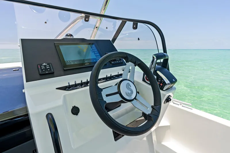  Yacht Photos Pics 2025 Beneteau Flyer 9 SUNdeck helm with steering wheel and navigation display.