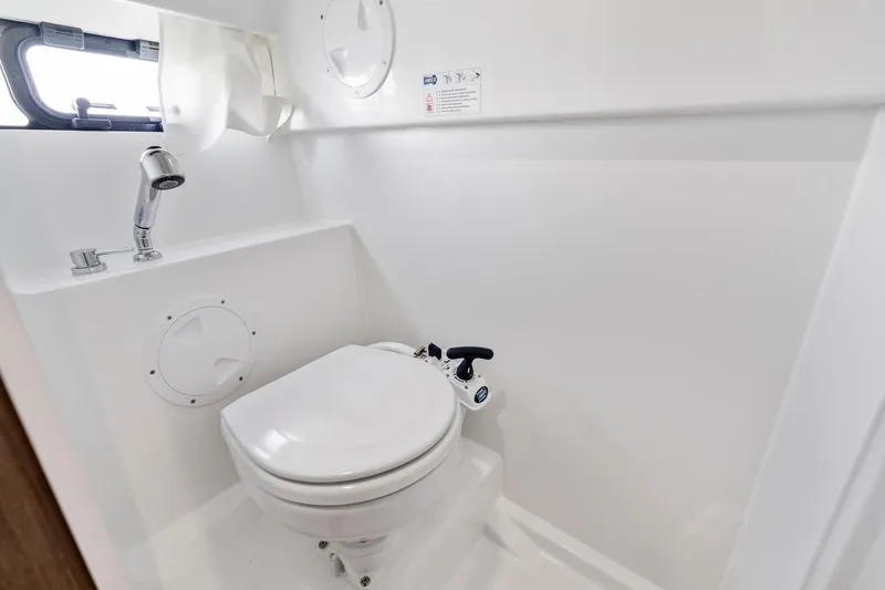  Yacht Photos Pics 2025 Beneteau Flyer 9 SUNdeck bathroom with compact toilet and sink.