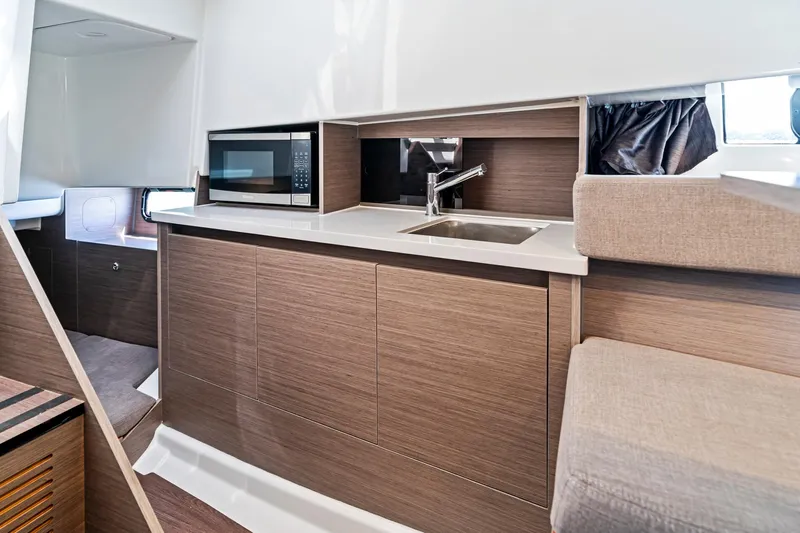  Yacht Photos Pics 2025 Beneteau Flyer 9 SUNdeck interior with kitchenette, featuring a sink and microwave.
