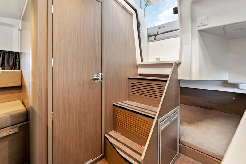  Yacht Photos Pics Interior of 2025 Beneteau Flyer 9 SUNdeck, featuring wooden stairs and cozy cabin space.