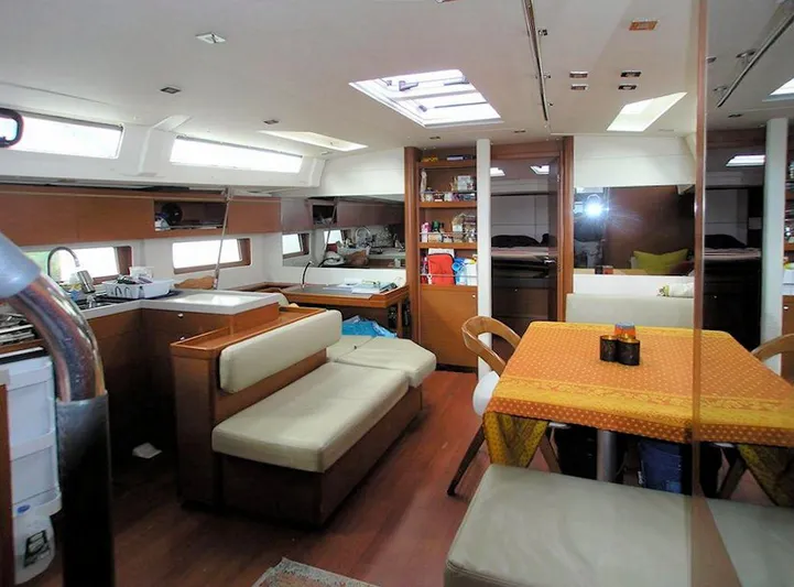  Yacht Photos Pics Interior of 2019 Beneteau 51.1 yacht with dining area and modern furnishings.