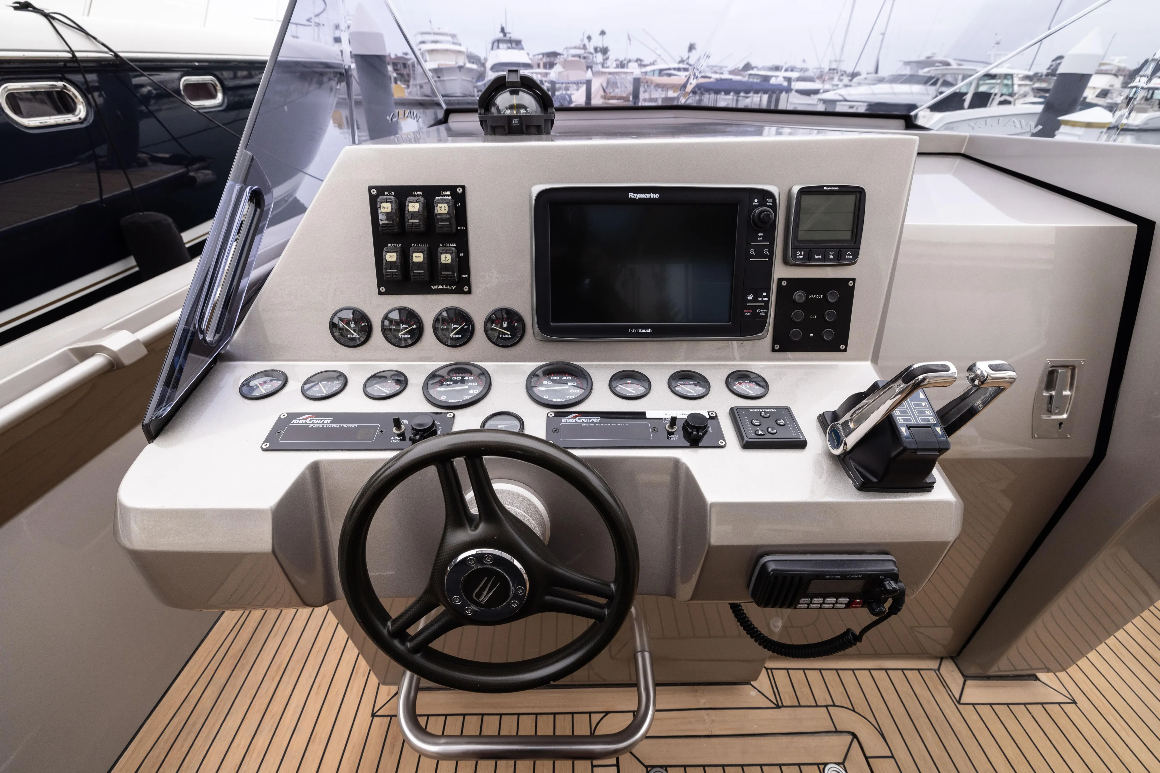 Fan Sea II Yacht Photos Pics 2005 Wally Yachts Tender Express dashboard with steering wheel, gauges, and navigation equipment.