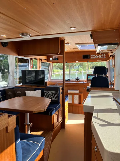  Yacht Photos Pics Interior of a 2016 Targa 44 CFC boat with wooden finishes and blue seating.