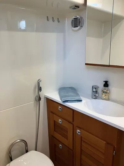  Yacht Photos Pics Modern Targa 44 CFC 2016 yacht bathroom with wooden cabinets and sleek fixtures.